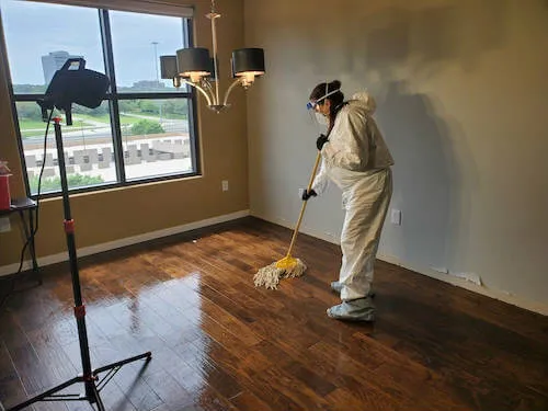 Technician : safely cleaning affected areas with personal protective equipment